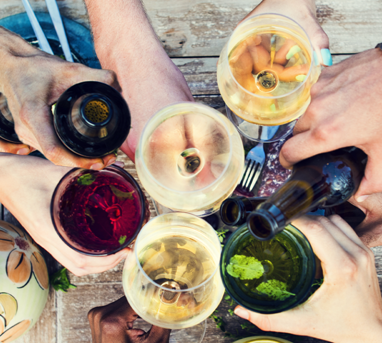 variety of beverages in hands of friends